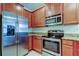 Stainless steel appliances and wood cabinets in kitchen at 31225 Claridge Pl, Wesley Chapel, FL 33543