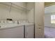 Laundry room with washer, dryer, and overhead shelving at 31225 Claridge Pl, Wesley Chapel, FL 33543