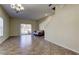 Living room with tiled floor, sliding glass door, and futon at 31225 Claridge Pl, Wesley Chapel, FL 33543