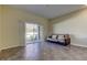 Living room featuring tiled floors, sliding glass doors, and a futon at 31225 Claridge Pl, Wesley Chapel, FL 33543