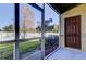 Screened porch with access to backyard and storage room at 31225 Claridge Pl, Wesley Chapel, FL 33543