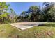 Sand volleyball court with a net and natural surroundings at 31225 Claridge Pl, Wesley Chapel, FL 33543