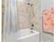 Bathroom with a shower/tub combo and updated tile at 3132 Nautical S Pl, St Petersburg, FL 33712