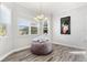 Bright dining area with large windows and a cozy round ottoman at 3132 Nautical S Pl, St Petersburg, FL 33712