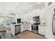 Modern kitchen with white cabinets, granite counters, and stainless steel appliances at 3132 Nautical S Pl, St Petersburg, FL 33712