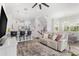 Open living space with light-colored sofa and a view of the kitchen at 3132 Nautical S Pl, St Petersburg, FL 33712