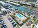 Community pool with lounge chairs and tropical landscaping near marina at 3132 Nautical S Pl, St Petersburg, FL 33712