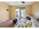 Bedroom with wood floors, ceiling fan, and access to deck at 353 144Th Ave, Madeira Beach, FL 33708
