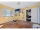 Bedroom with hardwood floors and large TV at 353 144Th Ave, Madeira Beach, FL 33708