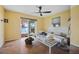 Bedroom with wood floors, ceiling fan, and water views at 353 144Th Ave, Madeira Beach, FL 33708