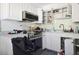 A different angle of the kitchen, showing the stove and sink area at 353 144Th Ave, Madeira Beach, FL 33708