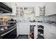 View of the kitchen with white cabinets and stainless steel appliances at 353 144Th Ave, Madeira Beach, FL 33708