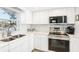 Well-equipped kitchen featuring stainless steel appliances and white cabinetry at 5020 Brittany S Dr # 213, St Petersburg, FL 33715