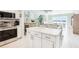 Modern white kitchen with stainless steel appliances and island at 5020 Brittany S Dr # 213, St Petersburg, FL 33715