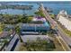 Aerial view of condo building, emphasizing its proximity to the water and bridge at 55 Harbor View Ln # 301, Belleair Bluffs, FL 33770
