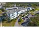 Aerial view of a condo building with parking and landscaping at 55 Harbor View Ln # 301, Belleair Bluffs, FL 33770