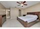 Bright bedroom with a large bed and dresser, plus access to the hallway at 55 Harbor View Ln # 301, Belleair Bluffs, FL 33770