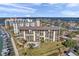 Stunning aerial view of a waterfront condo building with a pool and amazing water views at 650 Island Way # 106, Clearwater Beach, FL 33767