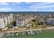Beautiful aerial view of a waterfront condo community with docks, a pool, and lush landscaping near the bay at 650 Island Way # 106, Clearwater Beach, FL 33767