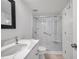 Updated bathroom with a walk-in shower, modern vanity, and tiled flooring at 650 Island Way # 106, Clearwater Beach, FL 33767
