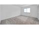 An ample-sized bedroom has a plush carpet, bright window, and closet with sleek doors at 650 Island Way # 106, Clearwater Beach, FL 33767
