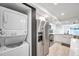 Well-equipped kitchen features stainless steel appliances with in-unit laundry at 650 Island Way # 106, Clearwater Beach, FL 33767