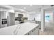 Modern kitchen boasts white cabinets, stainless appliances, and marble countertops at 650 Island Way # 106, Clearwater Beach, FL 33767