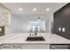 Bright kitchen offers marble countertops and stainless fixtures overlooking the living space at 650 Island Way # 106, Clearwater Beach, FL 33767