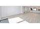 Spacious living room with light flooring leading to a modern kitchen at 650 Island Way # 106, Clearwater Beach, FL 33767