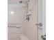 Bathroom shower with tiled walls and a chrome shower head at 650 Island Way # 106, Clearwater Beach, FL 33767