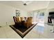 Dining area with a glass table, gold chairs, and sliding glass doors to the patio at 712 Gateway Ln, Tampa, FL 33613