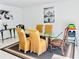 Dining room featuring a glass-top table, gold chairs, and decorative artwork at 712 Gateway Ln, Tampa, FL 33613