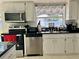 Kitchen equipped with stainless steel appliances, white cabinetry, and black countertops at 712 Gateway Ln, Tampa, FL 33613