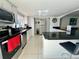 Kitchen featuring white cabinets, black countertops, stainless steel appliances, and a breakfast bar at 712 Gateway Ln, Tampa, FL 33613