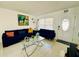 Living room with blue couches, glass coffee table, and decorative accents at 712 Gateway Ln, Tampa, FL 33613