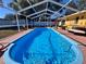 Screened-in pool with a paved deck area at 712 Gateway Ln, Tampa, FL 33613