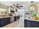 Modern kitchen with navy cabinets, stainless steel appliances, and a large island at 936 79Th S St, St Petersburg, FL 33707