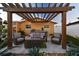 Relaxing patio with pergola, fire pit, and comfortable seating at 936 79Th S St, St Petersburg, FL 33707