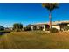 Expansive backyard with a lush lawn, mature landscaping and a screened lanai and view of the community at 1506 Bentwood Dr, Sun City Center, FL 33573