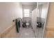 Small bathroom featuring a shower with a glass door, toilet, window and a decorative tiled floor at 1506 Bentwood Dr, Sun City Center, FL 33573