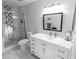 Updated bathroom with modern vanity, tiled floors, and a sleek glass-enclosed shower at 1506 Bentwood Dr, Sun City Center, FL 33573