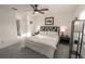 Inviting bedroom with plush carpet, ceiling fan, and neutral decor at 1506 Bentwood Dr, Sun City Center, FL 33573