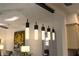 A pendant light fixture hangs above a dining area adjacent to the living area with a decorative painting on the wall at 1506 Bentwood Dr, Sun City Center, FL 33573