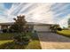 Attractive single-story home showcasing a manicured lawn and paver driveway at 1506 Bentwood Dr, Sun City Center, FL 33573