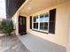 Inviting front entrance with a solid wood door and decorative window, complimented by a quaint walkway and manicured shrubbery at 1506 Bentwood Dr, Sun City Center, FL 33573