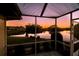Relaxing lanai view overlooking a tranquil pond and stunning sunset in a peaceful neighborhood at 1506 Bentwood Dr, Sun City Center, FL 33573