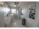 Functional laundry room with washer, dryer, and white cabinets for storage, with natural light from two windows at 1506 Bentwood Dr, Sun City Center, FL 33573