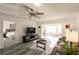 Comfortable living room with wood floors, ceiling fan, and access to sunroom and bedroom at 1506 Bentwood Dr, Sun City Center, FL 33573