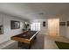 Open-concept living area with pool table, bar, and entryway at 1506 Bentwood Dr, Sun City Center, FL 33573