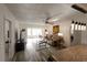 Open-concept living room with wood floors, ceiling fan, comfortable furniture, and view of the screened lanai at 1506 Bentwood Dr, Sun City Center, FL 33573